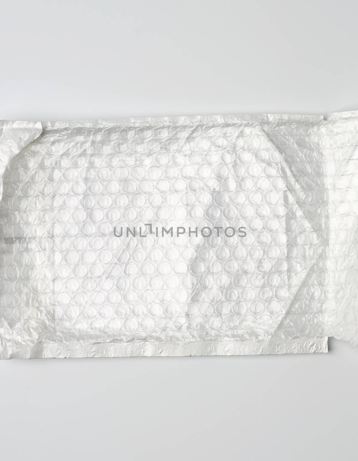 fragment of a transparent film with air for the transportation of parcels is glued on white polyethylene, inside of the envelope