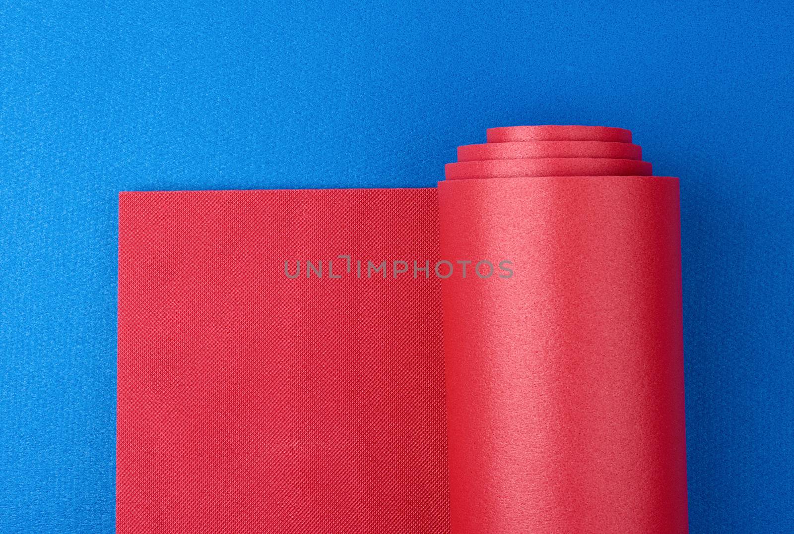 neoprene red twisted mat lies on a blue mat, sports equipment, copy space