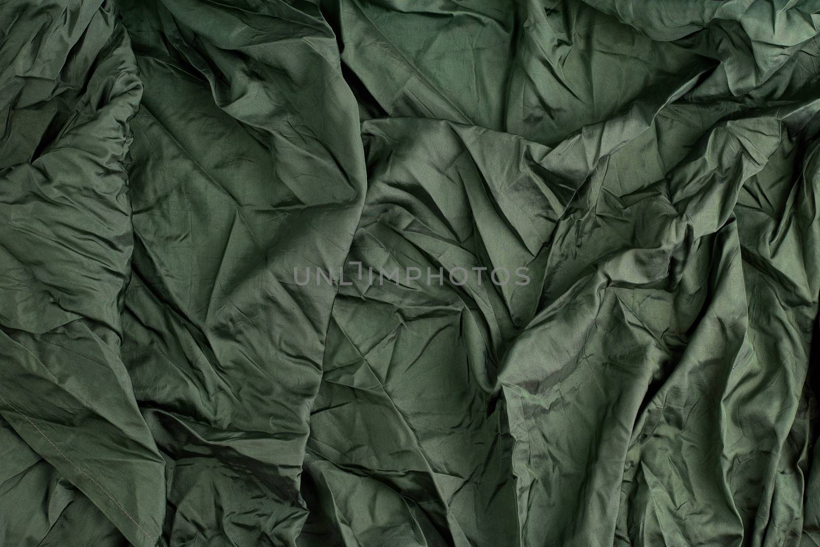 green satin textile fabric, piece of fabric for sewing curtains and things, full frame