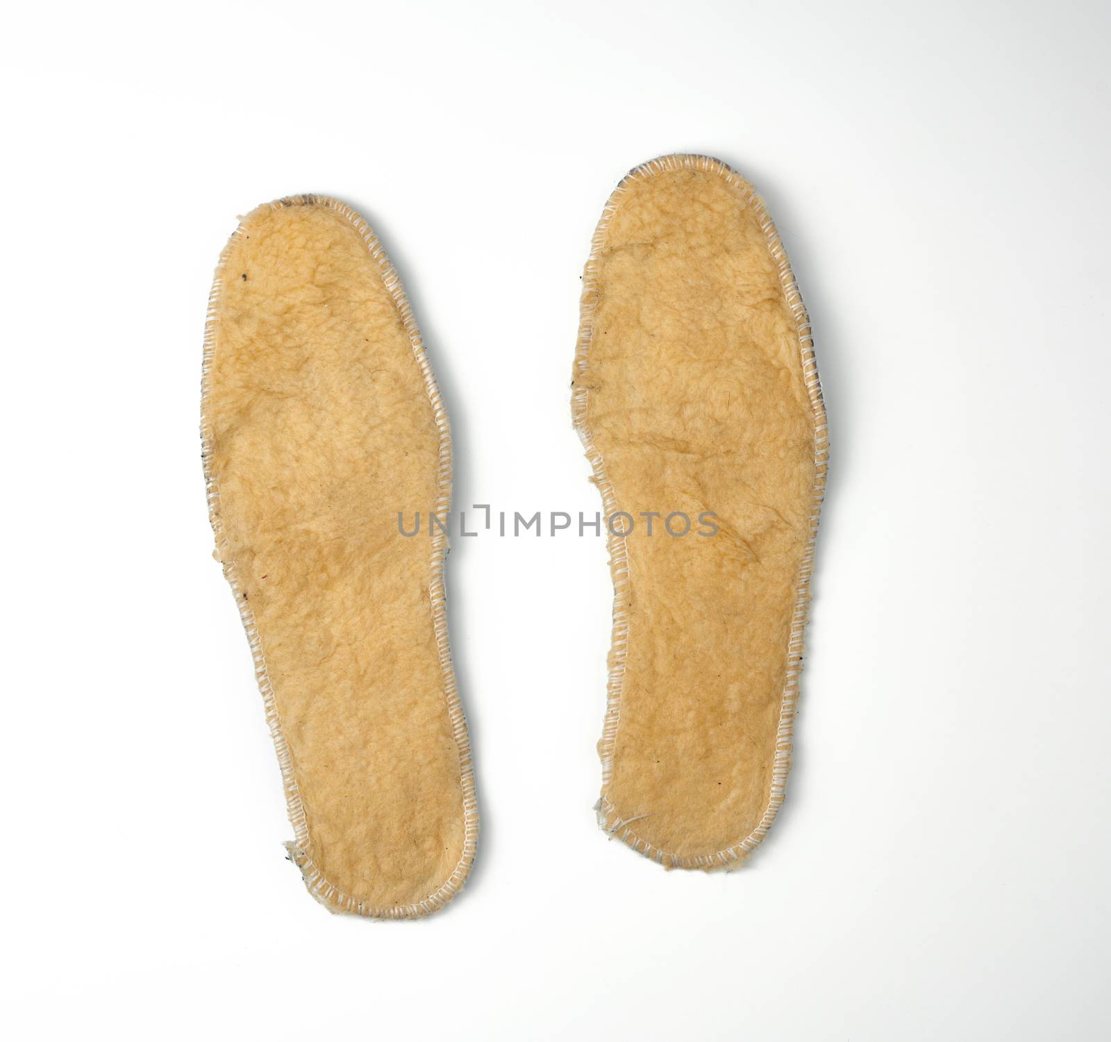 pair of shoe insoles with insulation and fleece on a white background, top view