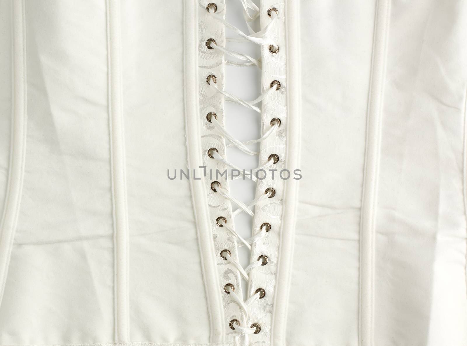 fragment of a white satin corset with lacing, wrong side of clothes