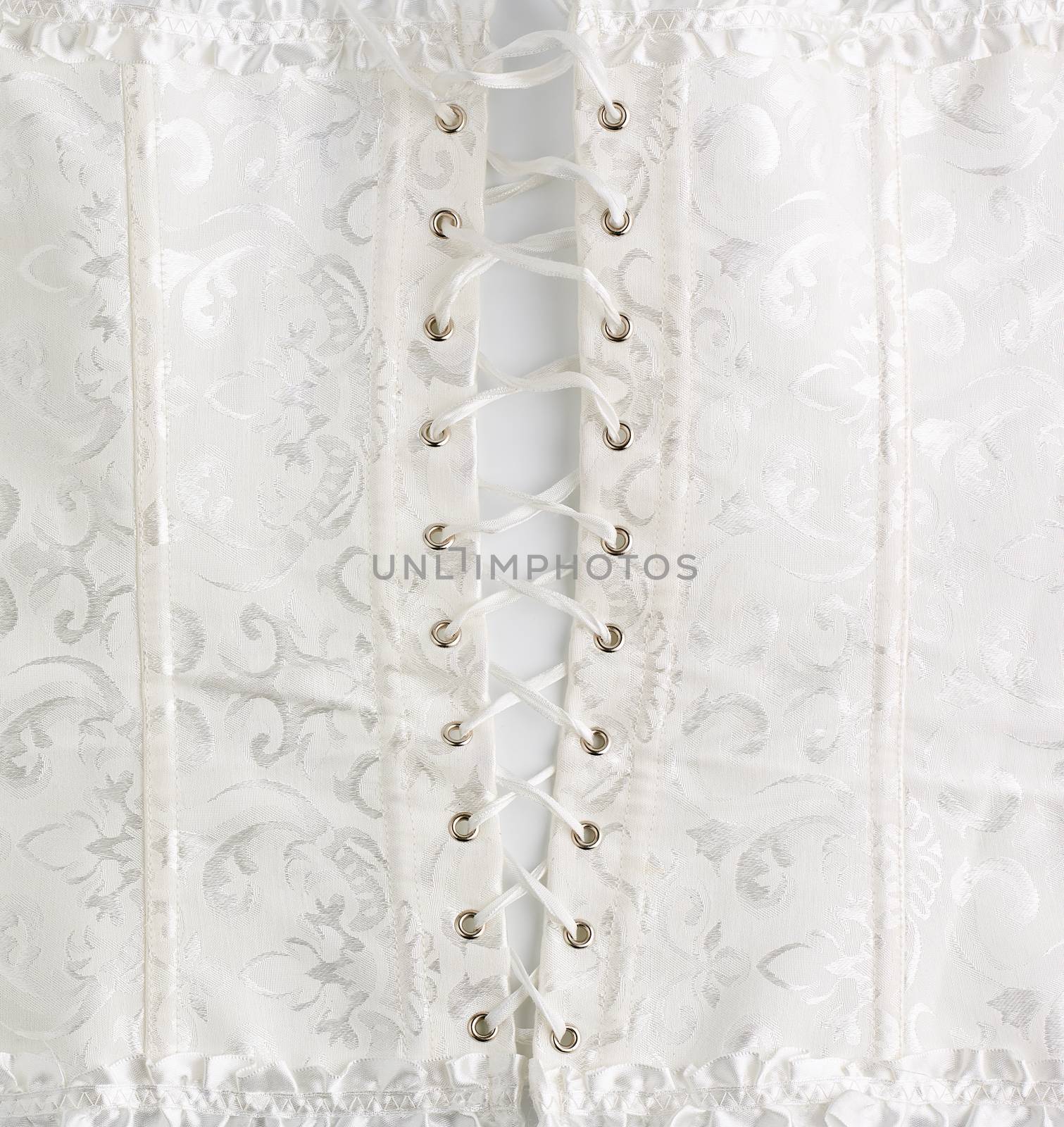 fragment of a white satin corset with lacing, back view, clothing item for brides, close up
