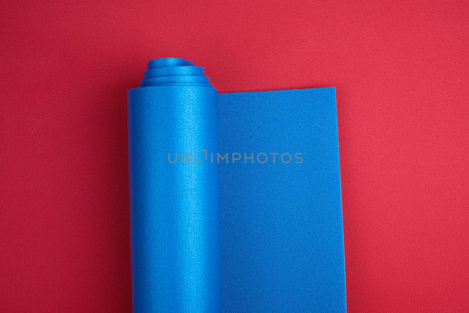 neoprene blue twisted mat lies on a red background, sports equip by ndanko