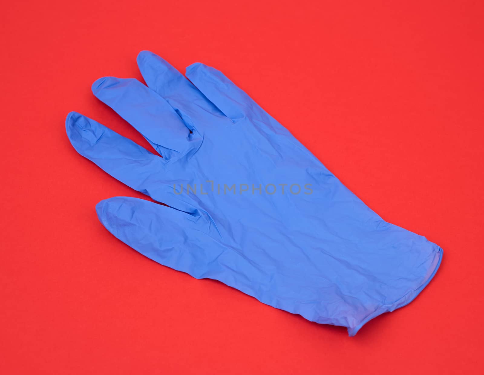 blue medical rubber glove for carrying out procedures and manipulations, subject is isolated on a white background