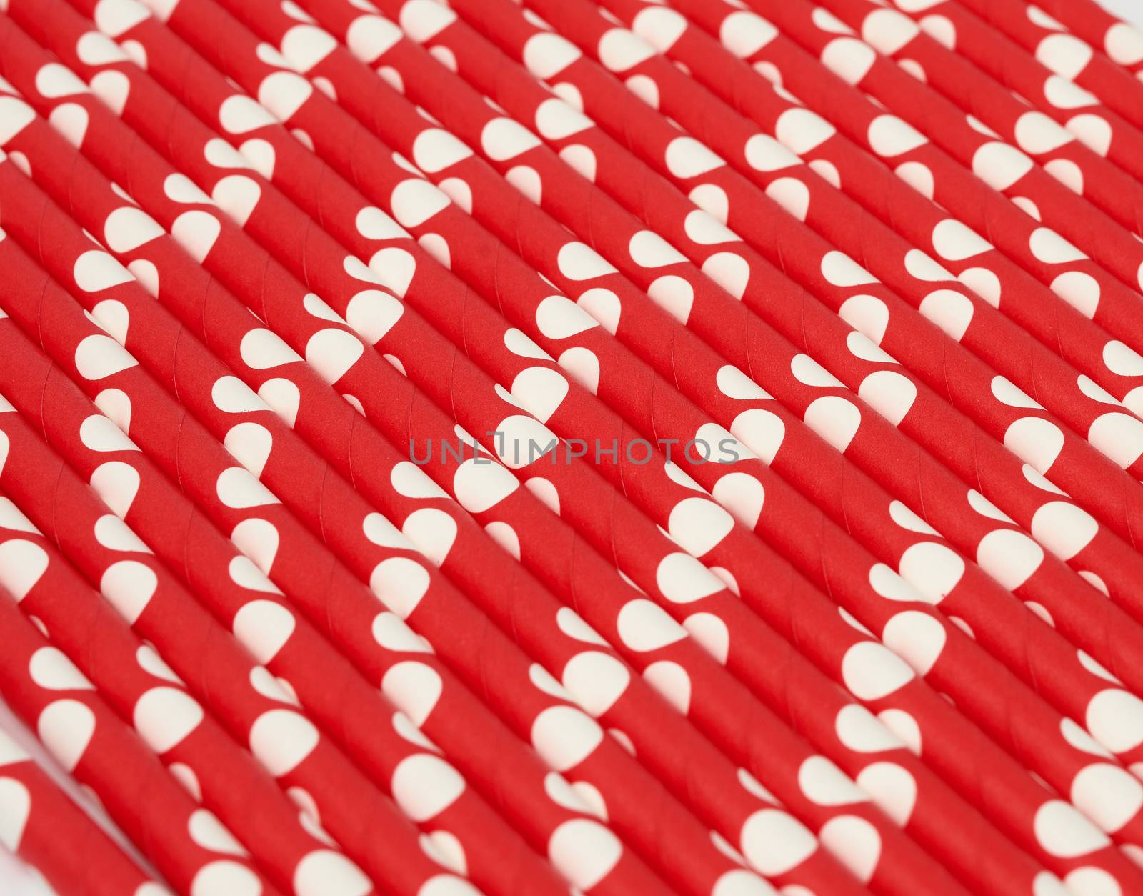 red paper cocktails with white polka dots, close up