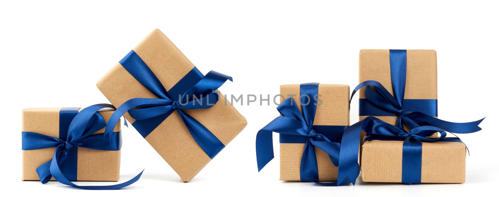 rectangle box wrapped in brown kraft paper and tied with a silk blue ribbon, gift isolated on a white background, set