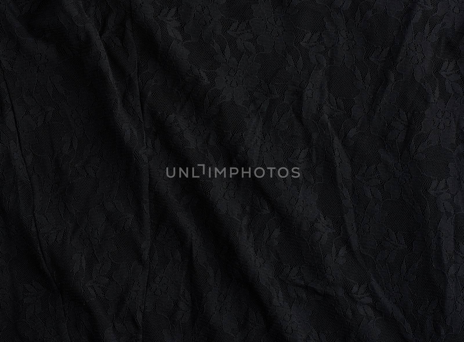 texture of crumpled black synthetic fabric guipure for sewing clothes, full frame