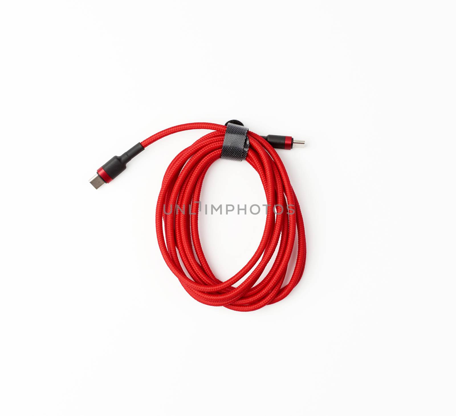 twisted cable for charging mobile devices in a red textile wrapper on a white background