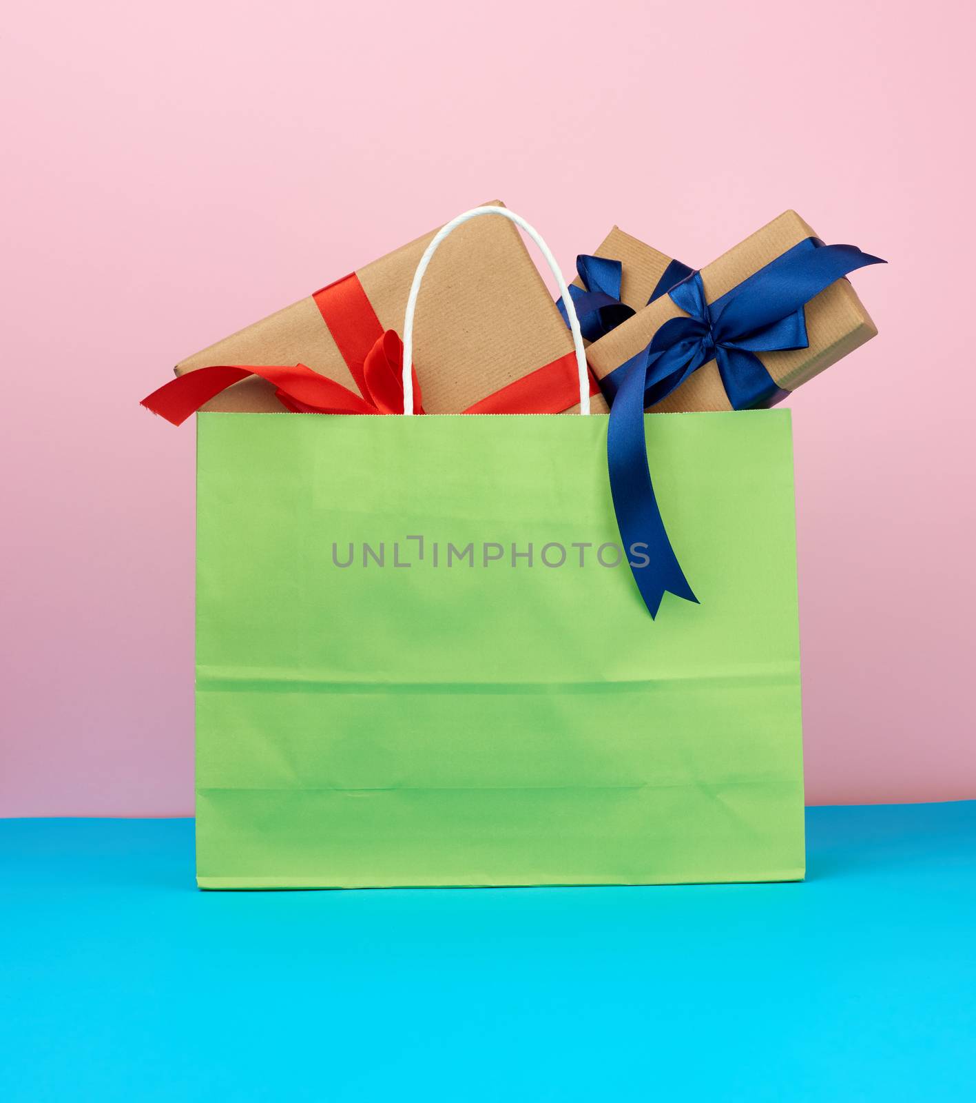 pink paper bag with a gift box, concept of shopping and giving a gift