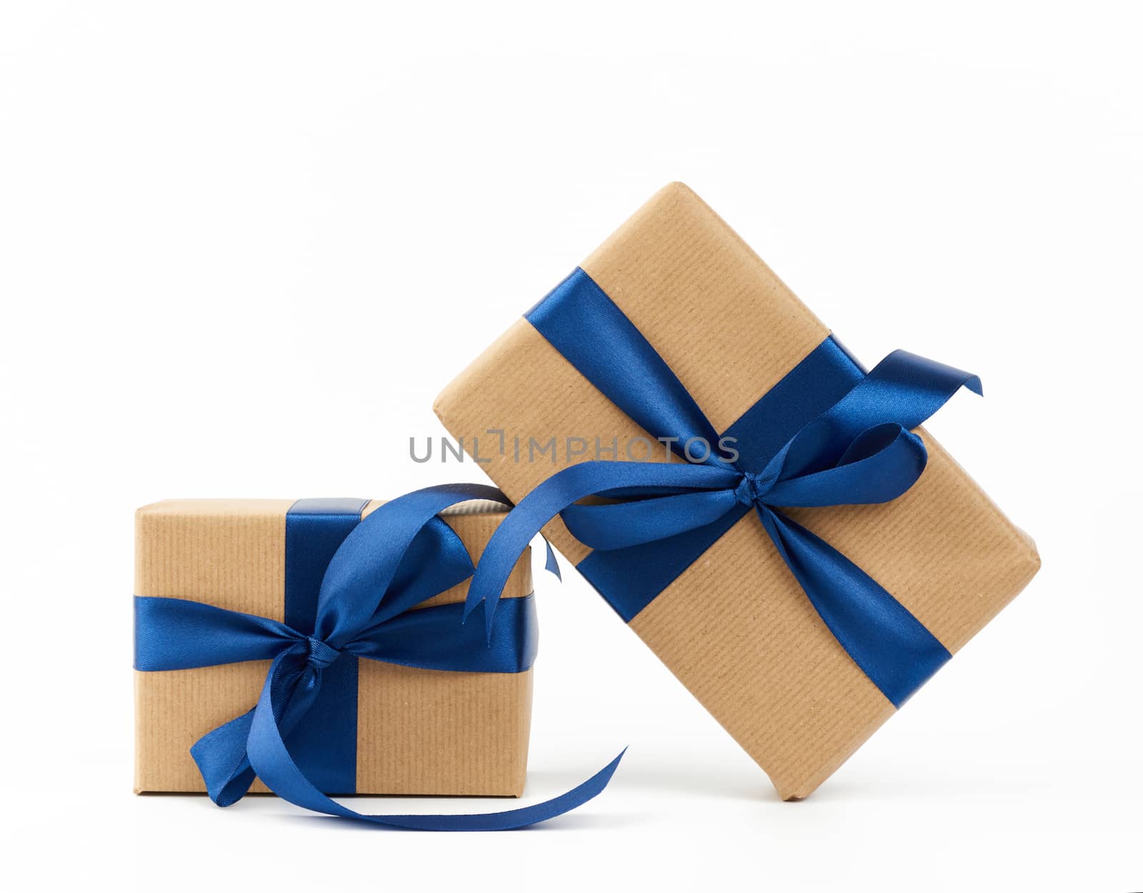 rectangle box wrapped in brown kraft paper and tied with a silk blue ribbon, gift isolated on a white background