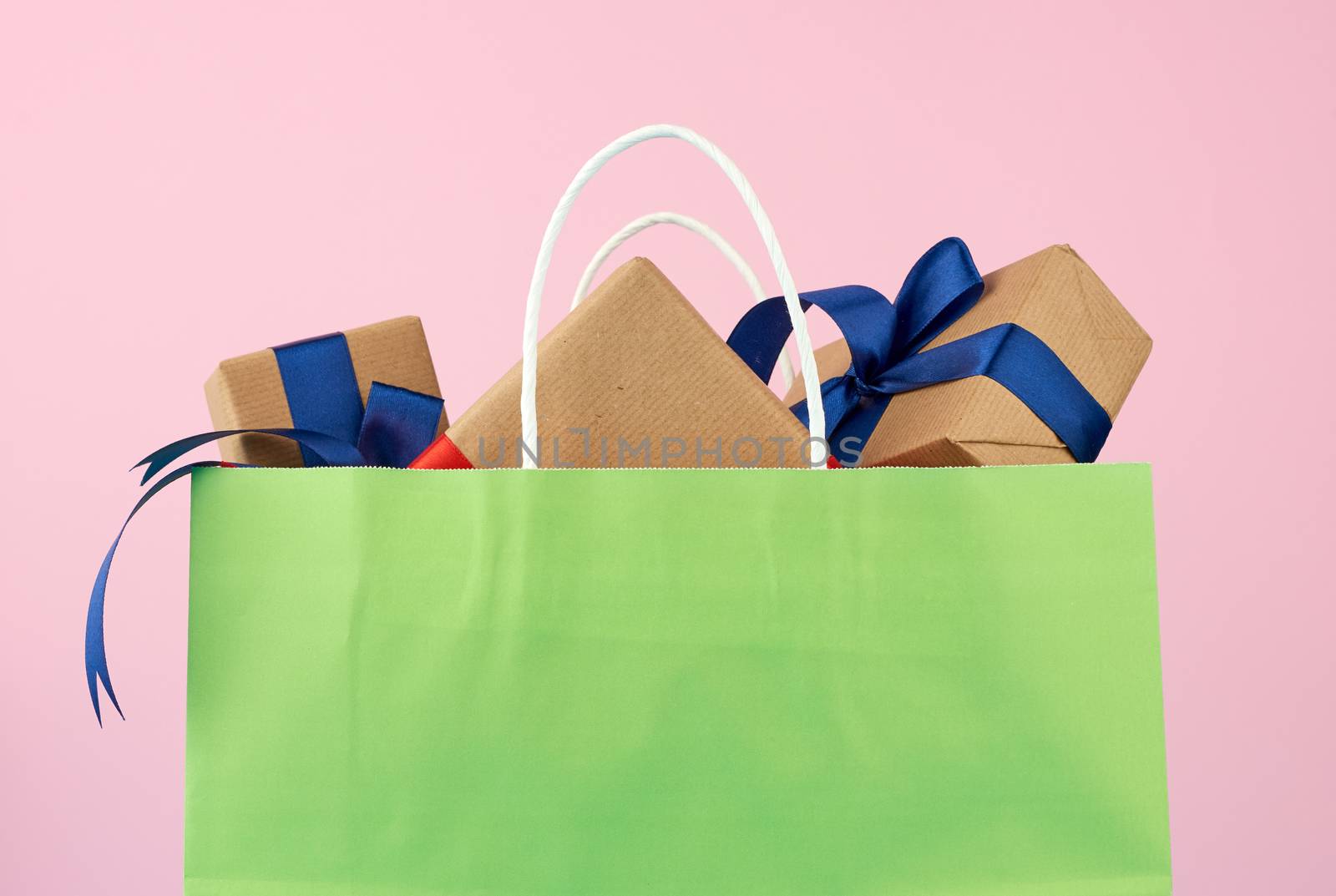 green paper bag with a gift box, concept of shopping, close up