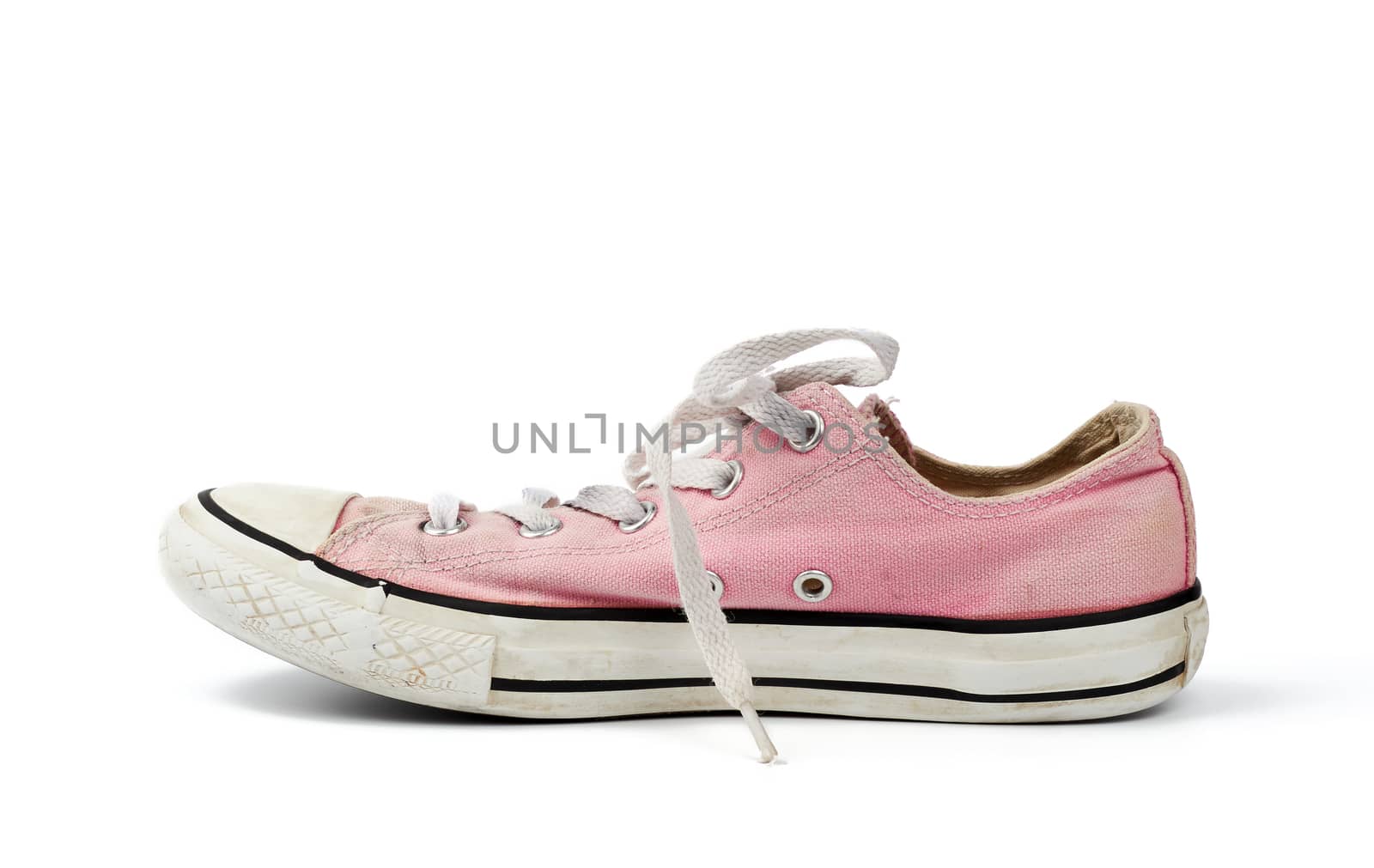 one light pink worn textile sneaker with laces isolated on a white background, side view