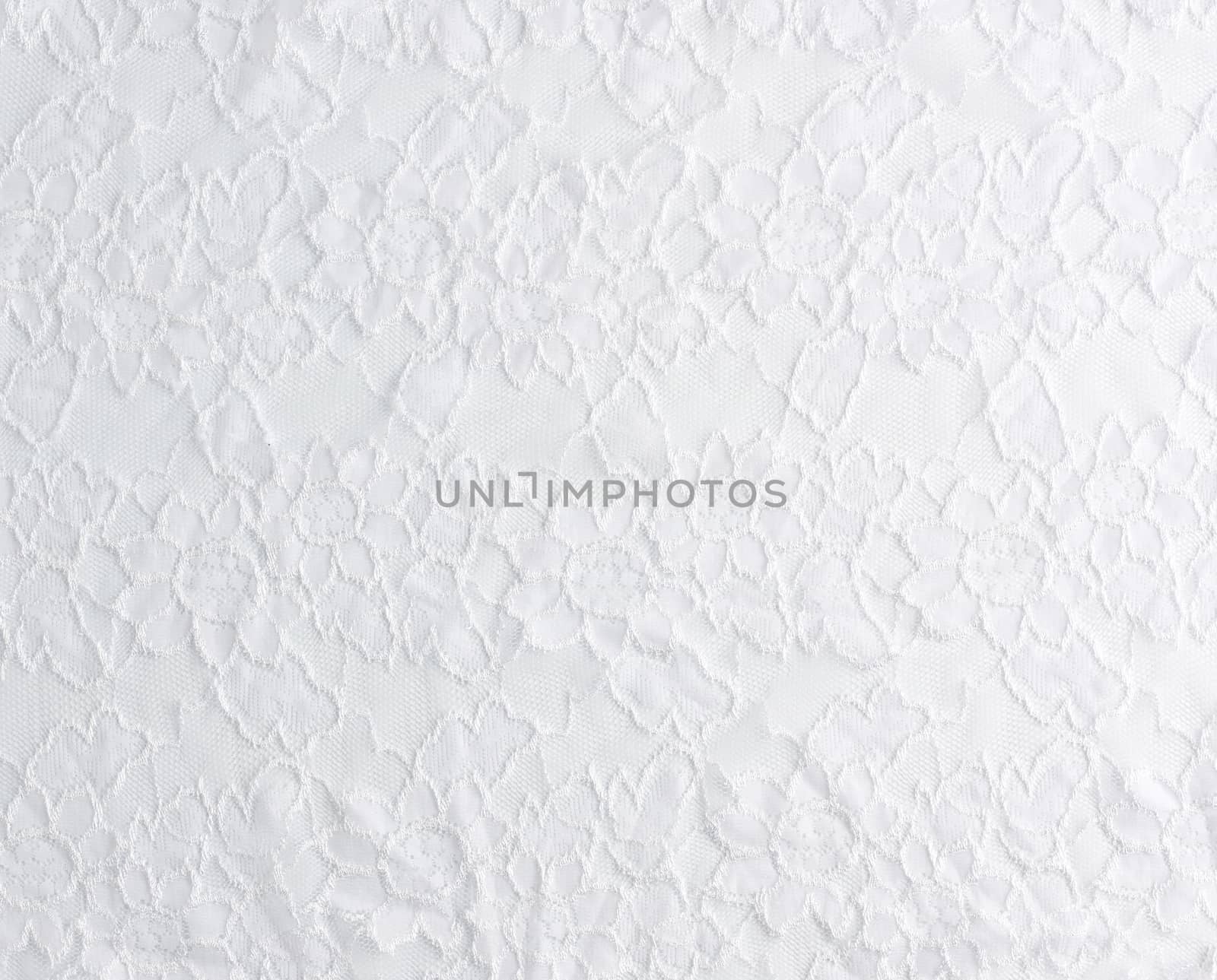 texture of crumpled white synthetic fabric guipure for sewing clothes on a white background, full frame