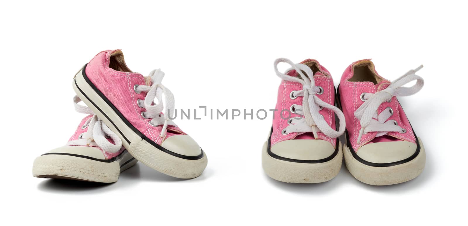 pair of pink children's textile sneakers with white laces isolated on a white background, old shoes, set