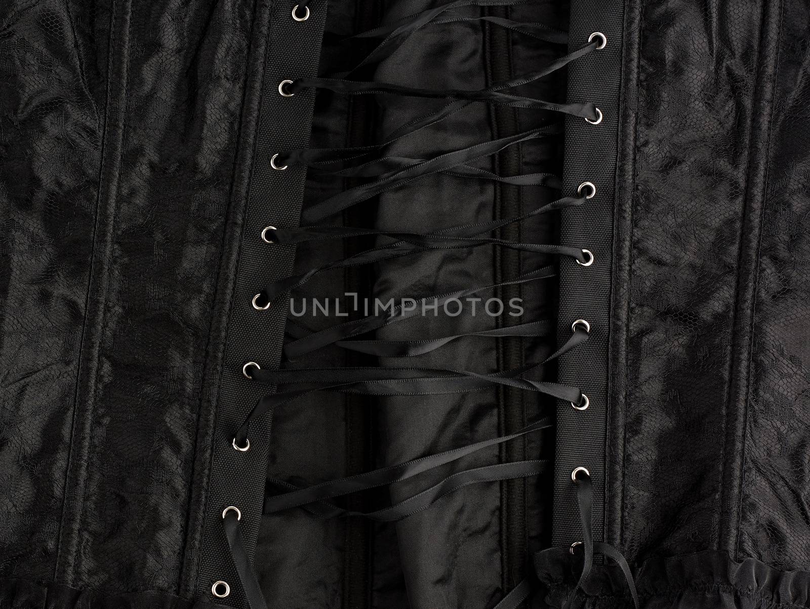 fragment of a black satin corset with lacing, back view, clothing item