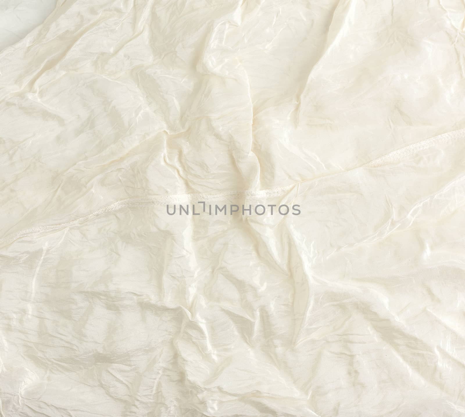 crumpled beige synthetic fabric for the manufacture of lining for skirts, full frame