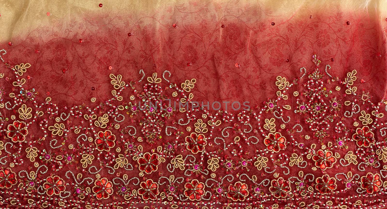 crumpled red yellow tulle with sewn red round sequins and embroidered bead pattern, fabric for sewing clothes, full frame