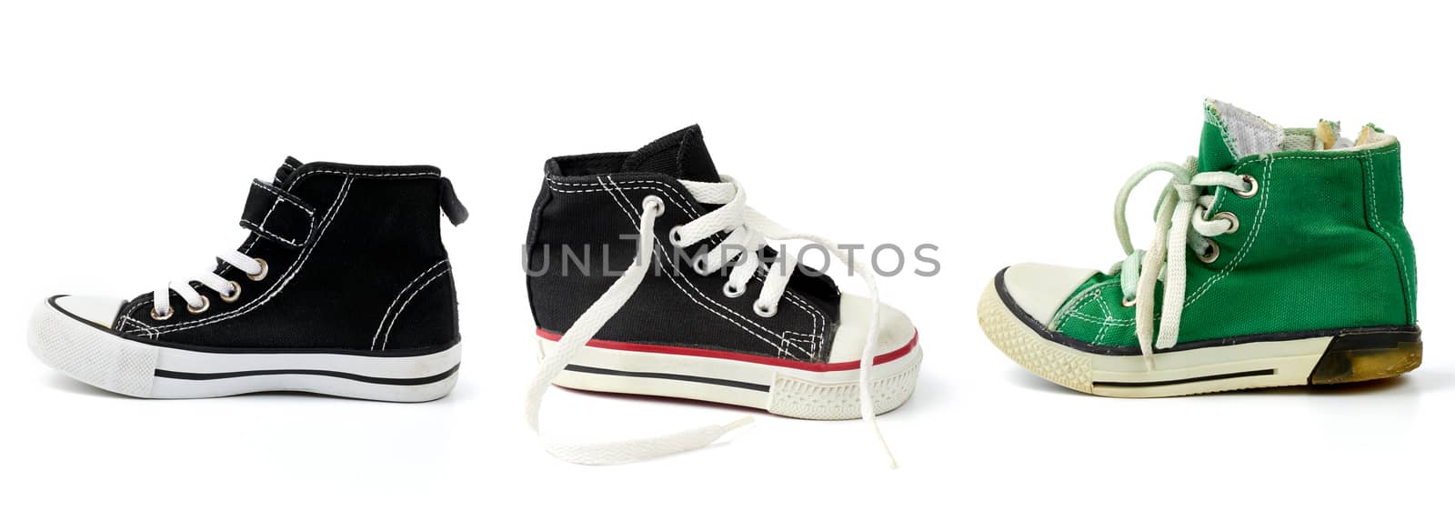 black, green textile sneakers  with white tied shoelaces on a white background, shoes stand sideways