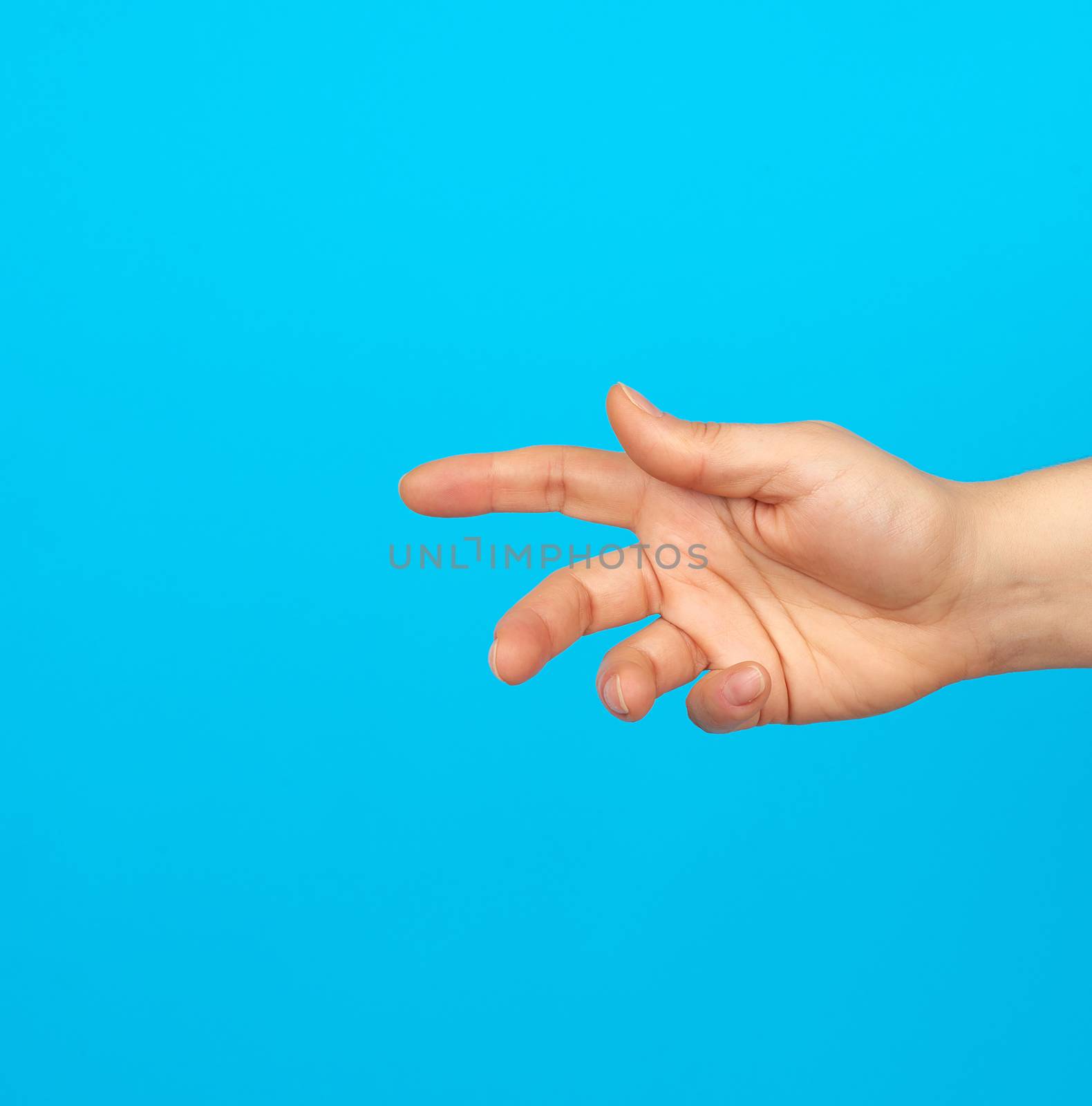 hand reaches to the side, gesture that shows holding the item in the palm, blue background