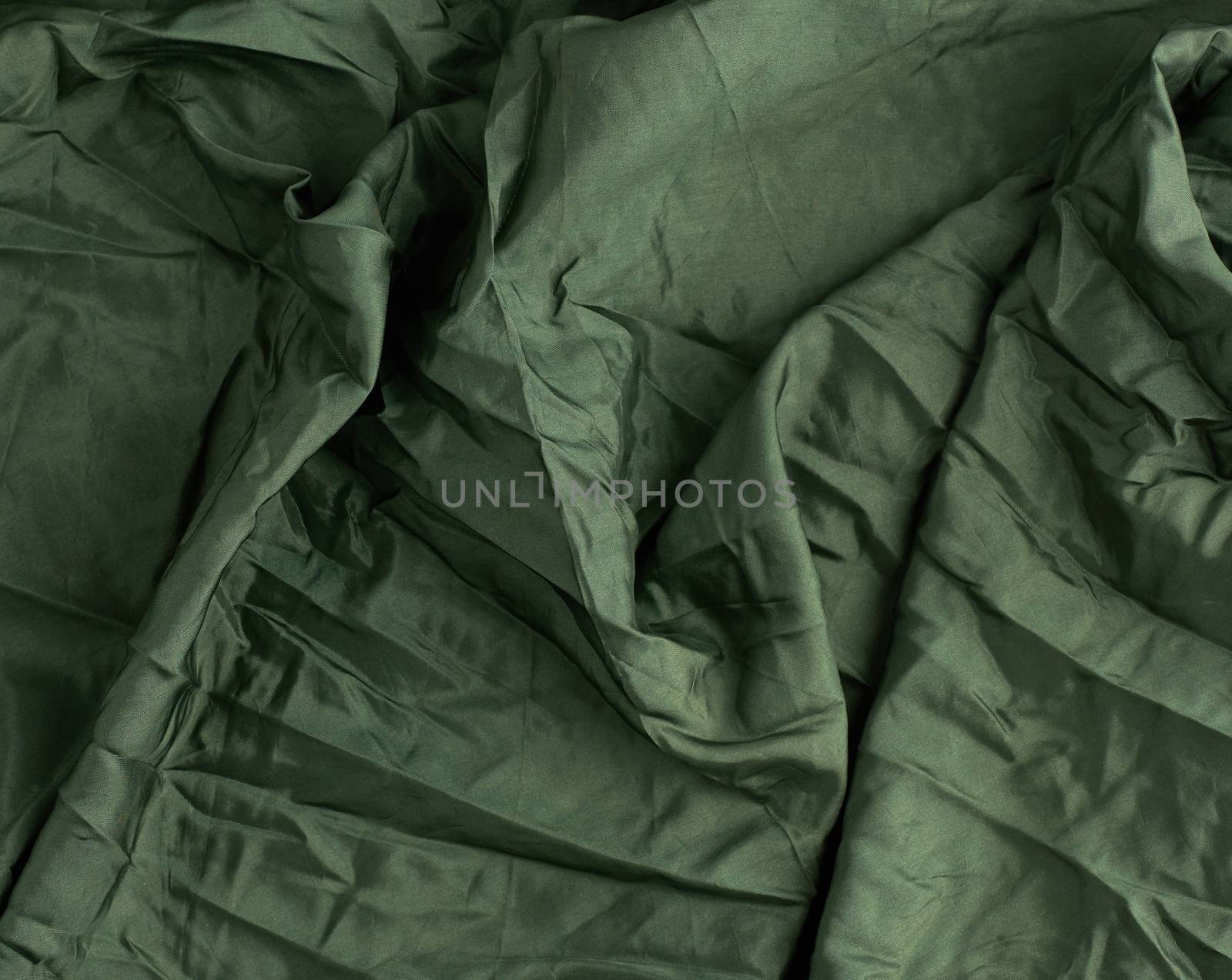 green satin textile fabric, piece of fabric for sewing curtains and things, full frame