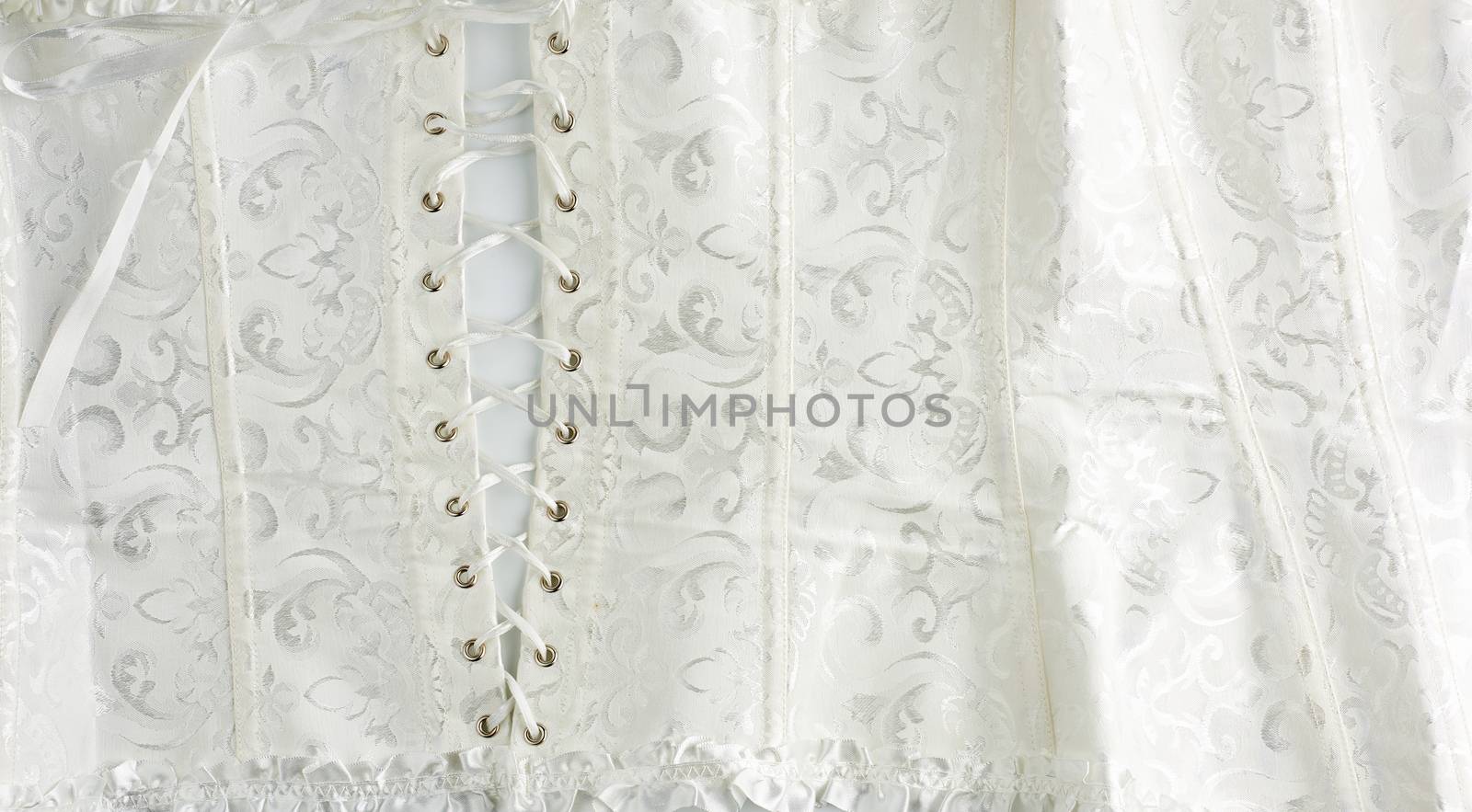 fragment of a white satin corset with lacing, back view, clothing item for brides