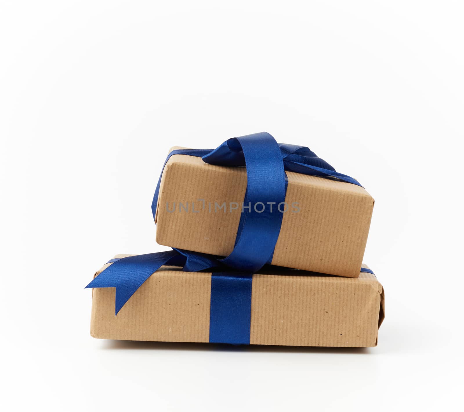 rectangle box wrapped in brown kraft paper and tied with a silk blue ribbon, gift isolated on a white background