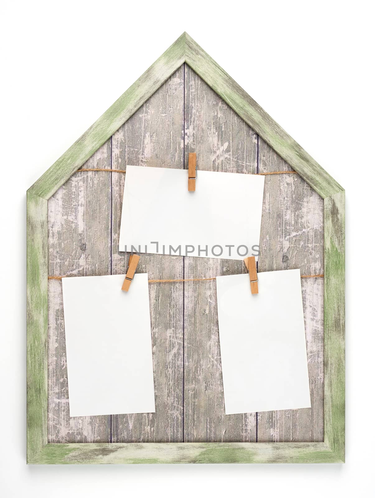 wooden frame with ropes and empty white paper sheets hanging on  by ndanko