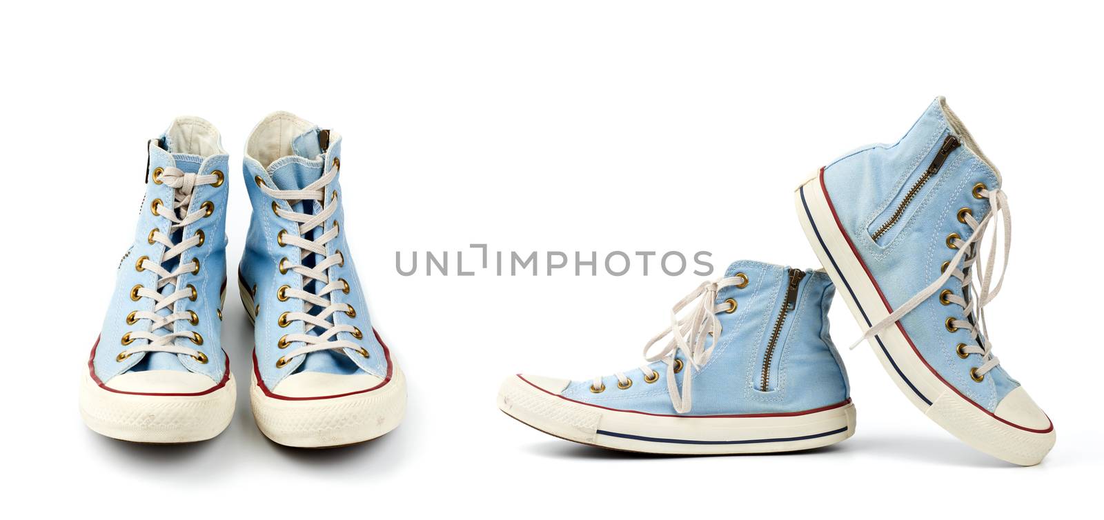 pair of light blue worn textile sneakers with laces and zippers on a white background, side view of shoes and front view, set