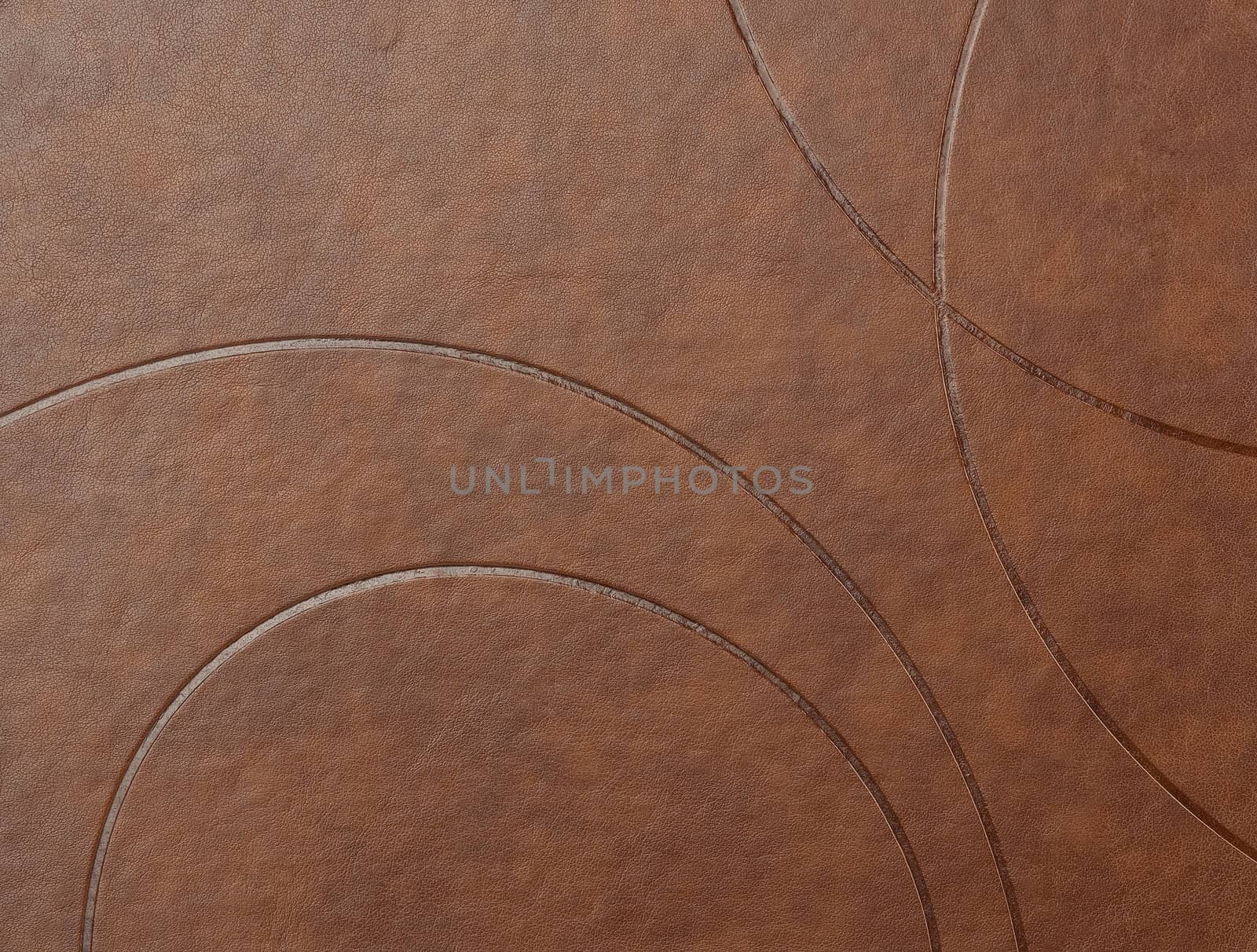texture of brown leather surface with embossed elements, full frame, close up