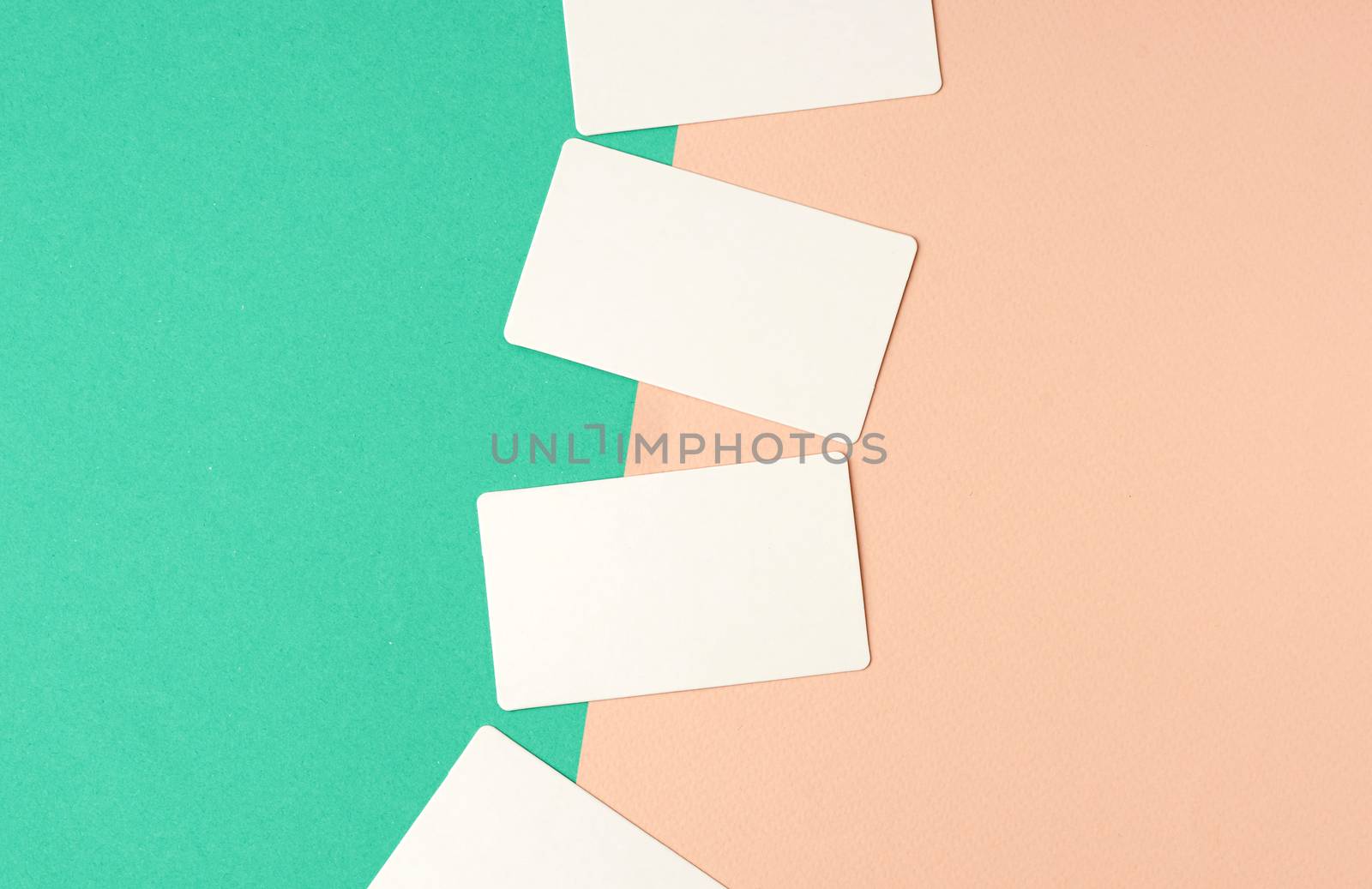 rectangular white blank business cards on a color background, backdrop for the designer