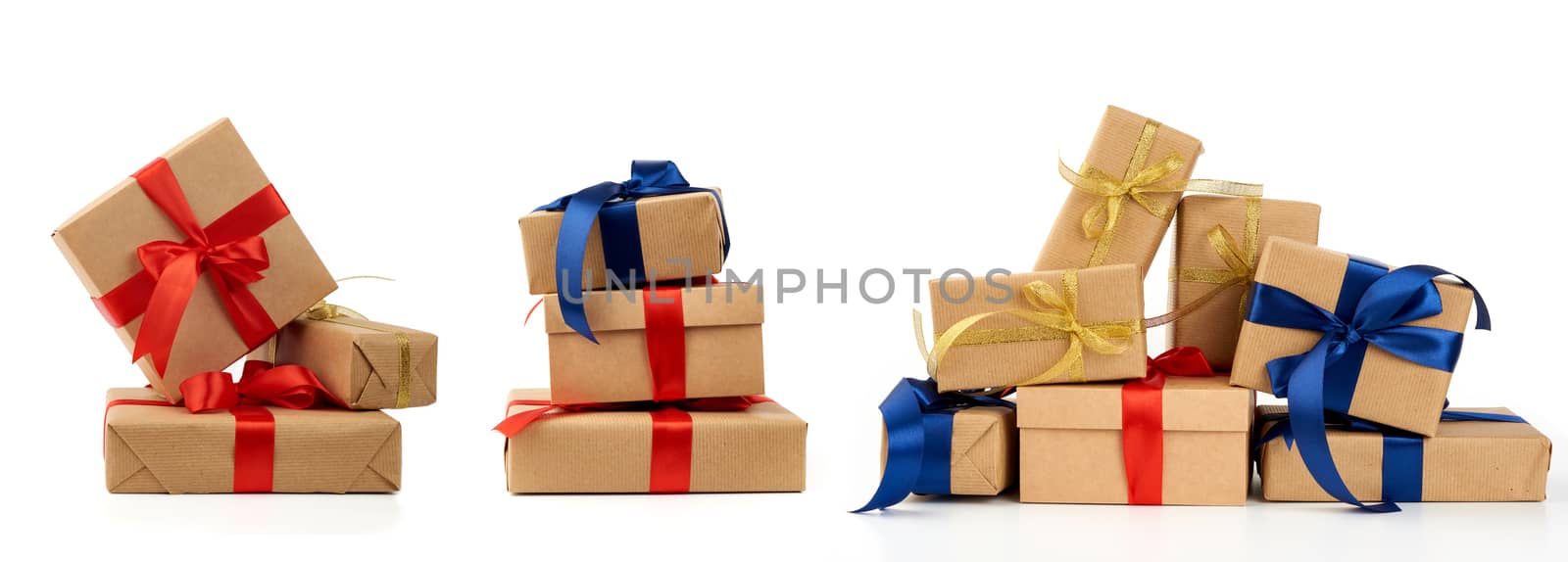 stack of gifts wrapped in brown kraft paper and tied with silk b by ndanko