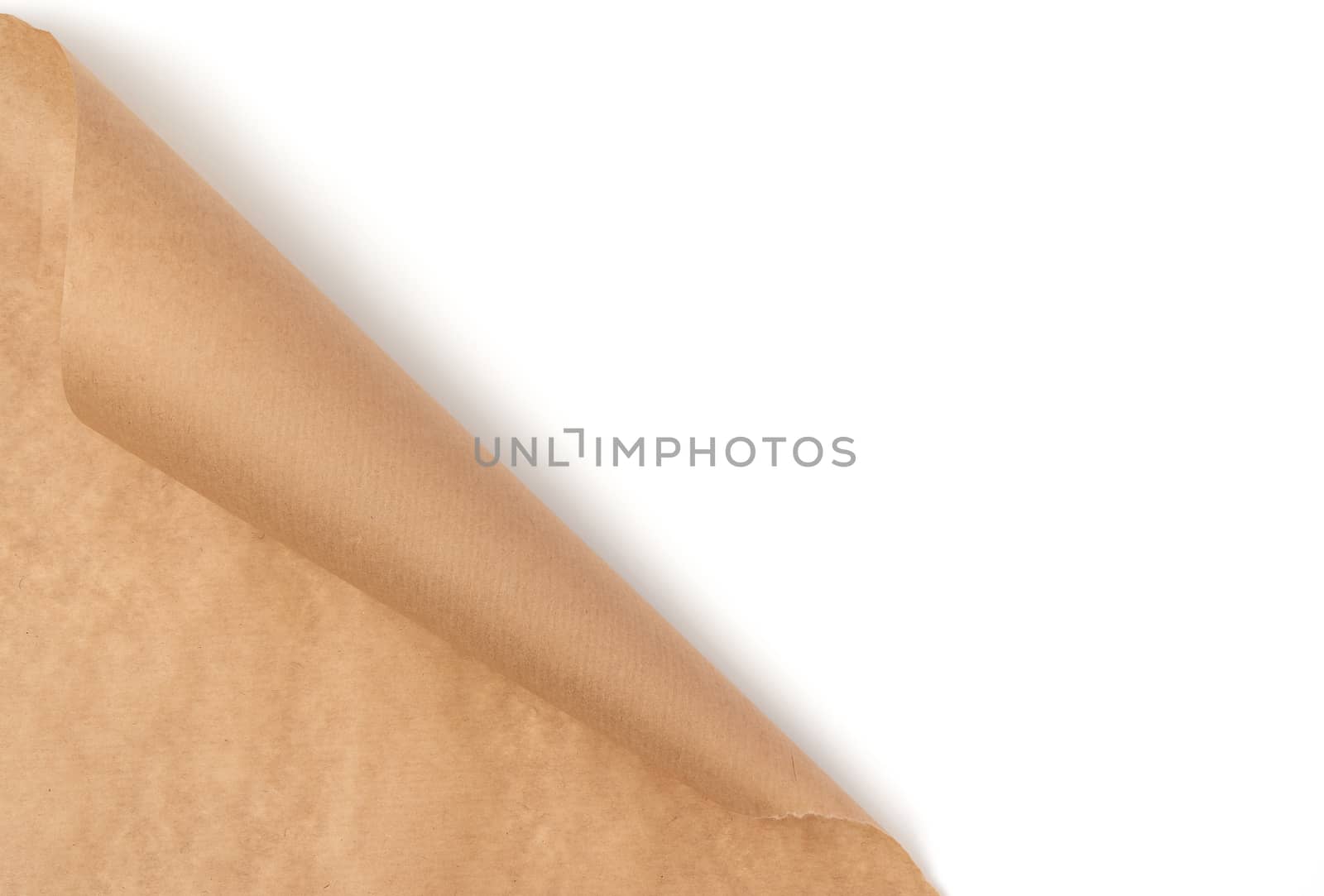 curved edge of a brown parchment paper sheet is isolated on a white background, place for an inscription