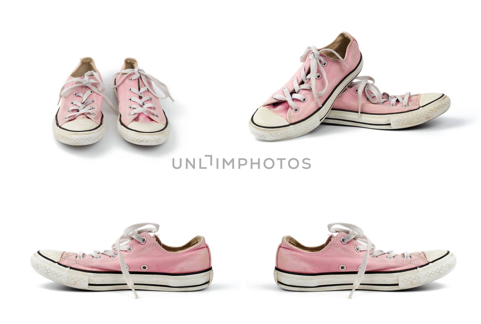 pair of light pink worn textile sneakers with laces isolated on a white background, front and side view, set