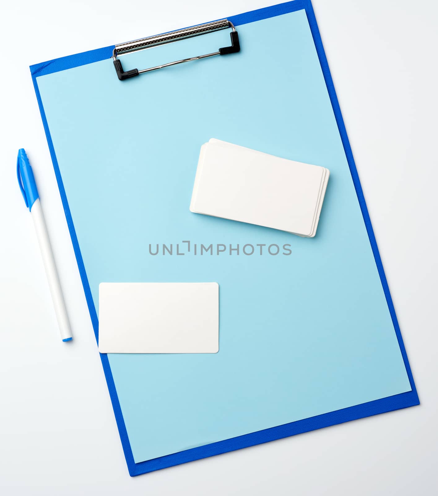 blue holder with clean blue sheets, pen, empty business card on a white background, copy space
