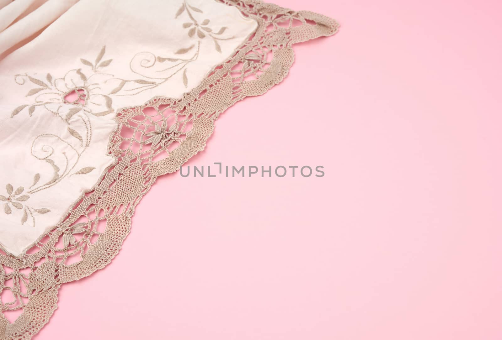 white kitchen textile towel folded on a pink background, copy space