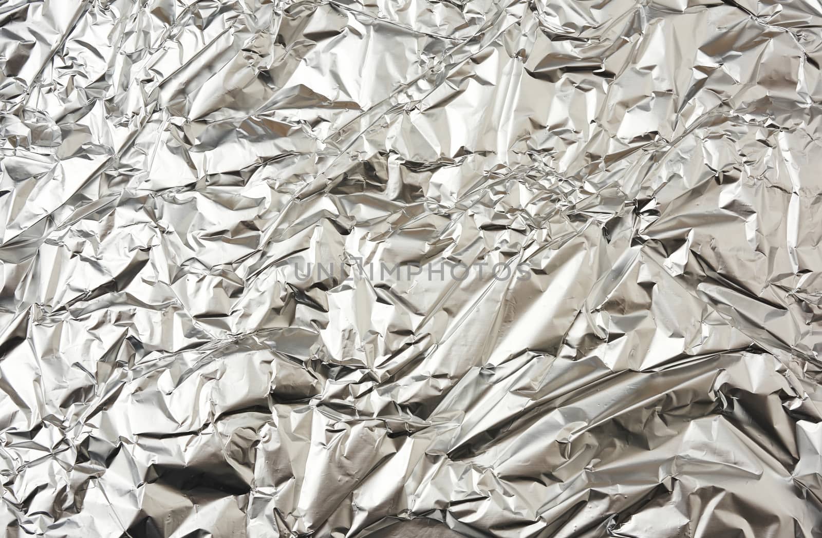 texture of matte crumpled piece of foil, food and objects packaging material, full frame