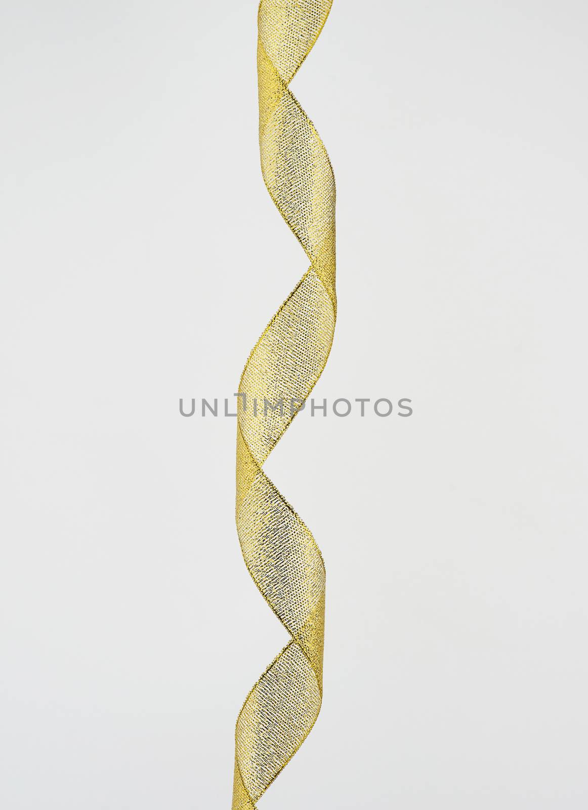 twisted golden silk decorative ribbon for packing gifts on a whi by ndanko