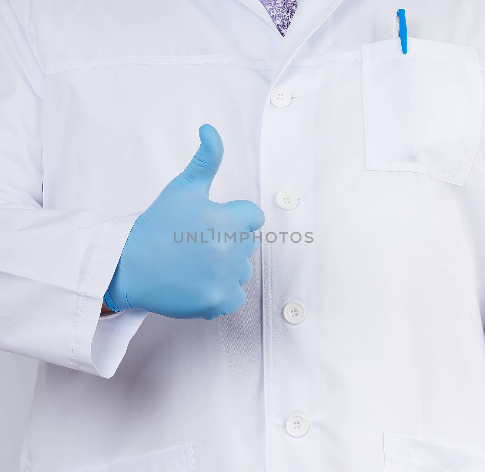 doctor in a white coat and tie shows with his hand a gesture like, wearing blue latex medical gloves, close up
