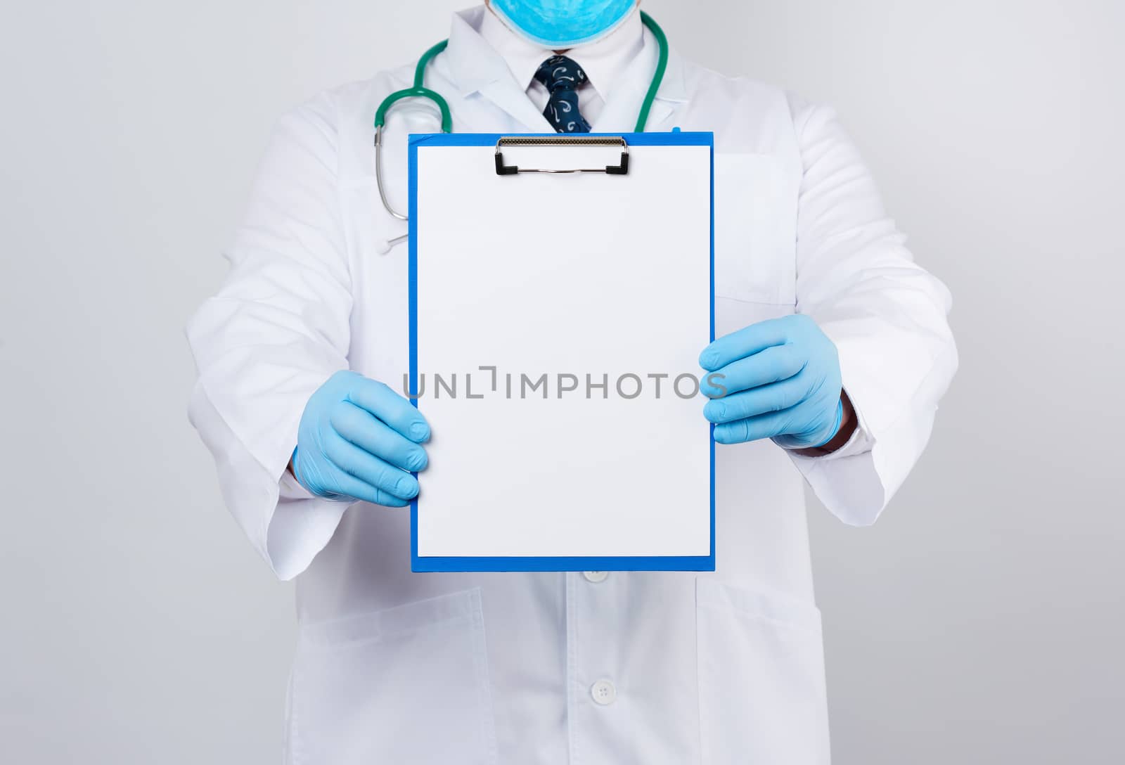 male doctor in a white coat, blue latex gloves, a stethoscope hanging on his neck, doctor holding a paper holder with a white blank sheet, place for writing a prescription and text