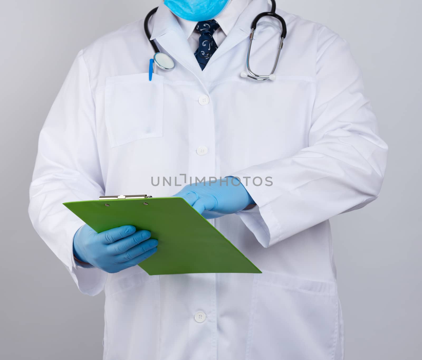 doctor in a white coat, blue latex gloves,  stethoscope hanging on his neck, he holding a paper clipboard 