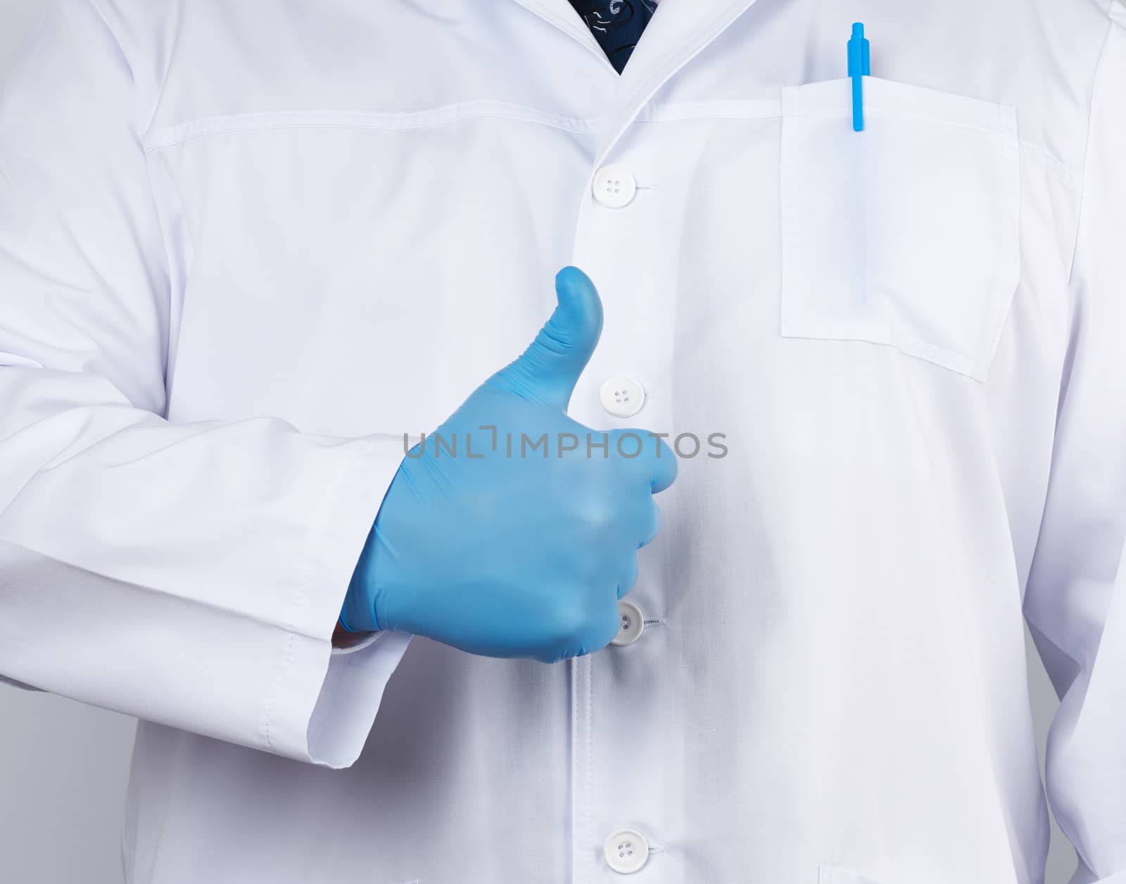 doctor in a white coat and tie shows with his hand a gesture like, wearing blue latex medical gloves, close up