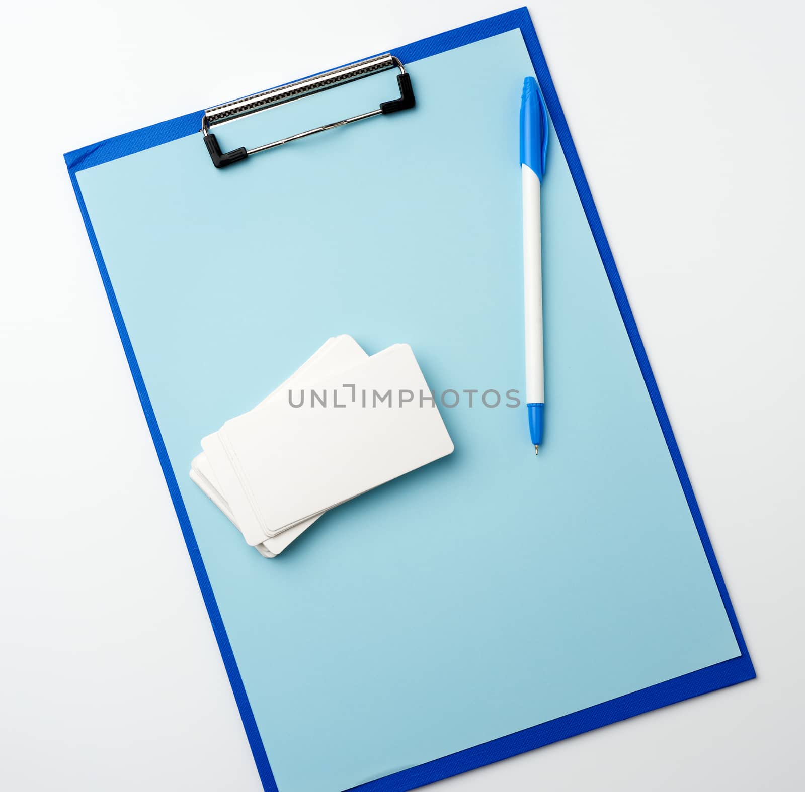 blue holder with clean blue sheets, pen, empty business card on a white background, copy space