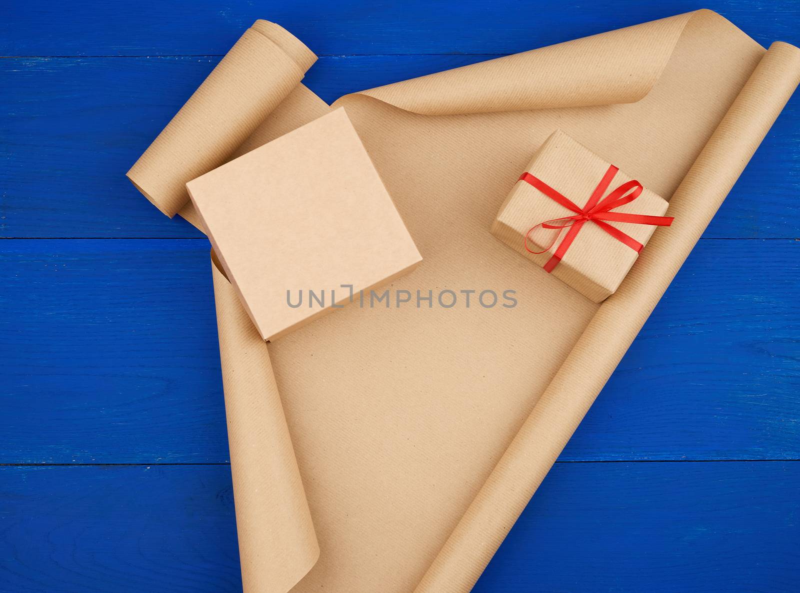brown kraft paper, packed gift boxes and tied with a red ribbon, set of items for making gifts. Gift wrapping. Package design