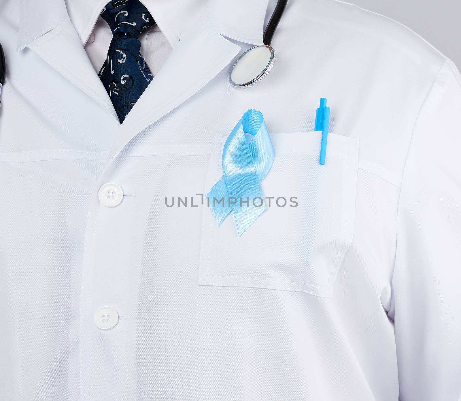 on the pocket pinned a blue ribbon in the shape of a loop, symbol of the fight and treatment of prostate cancer