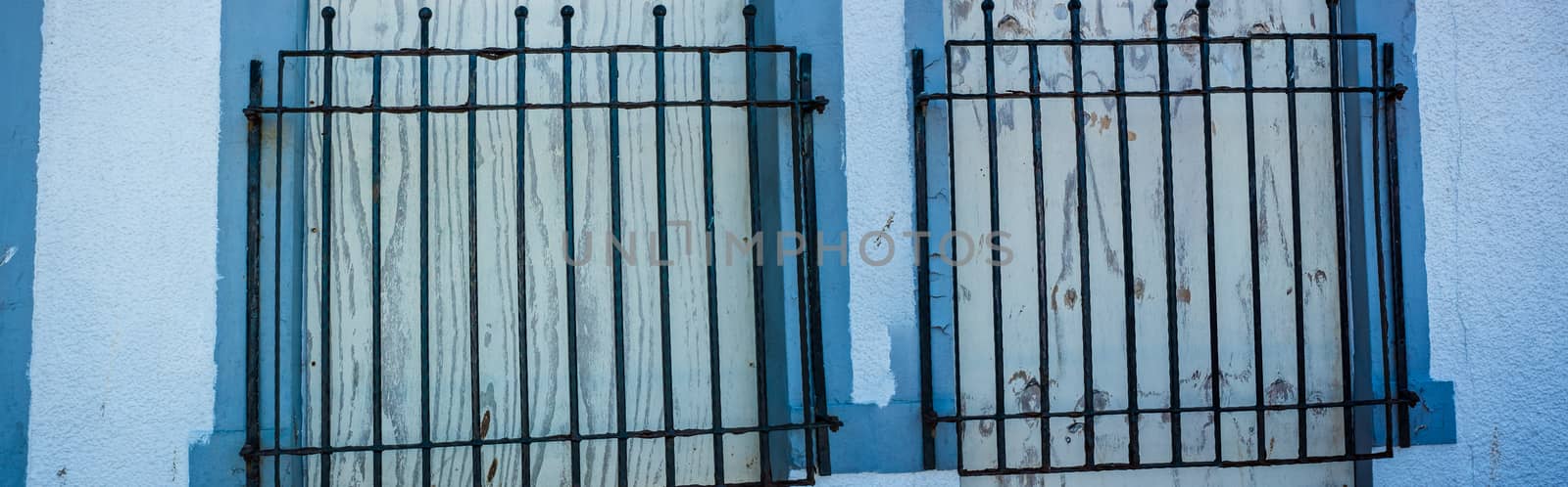 Panorama Close up of two Windows with black iron bars UK