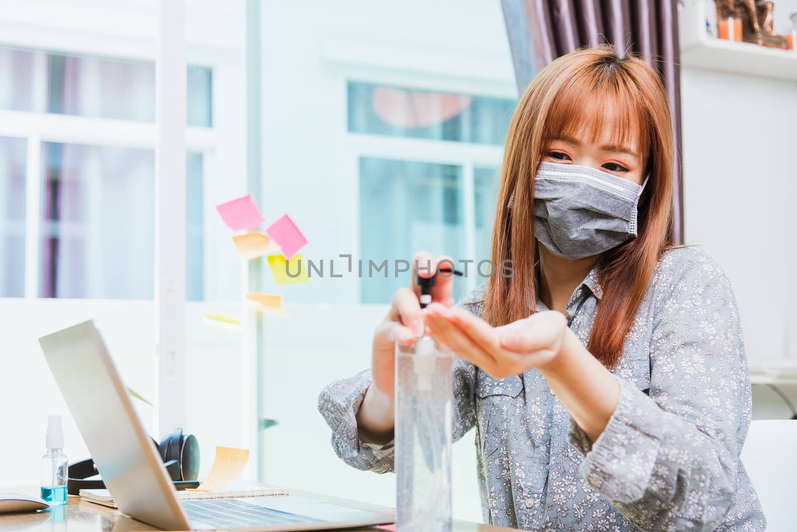 business woman wearing face mask protective cleaning hands with  by Sorapop