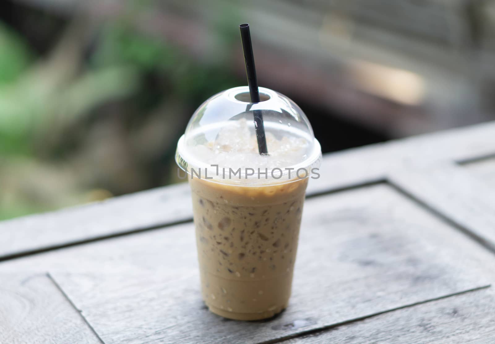 Close up glass of ice americano coffee on wood table, selective focus