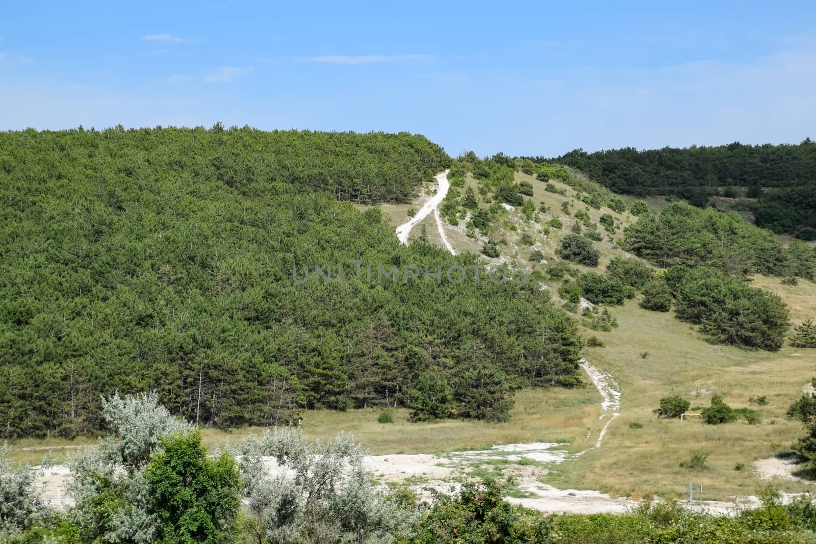 Landscapes of Crimean nature. Fields and hills visible from car window from the road.