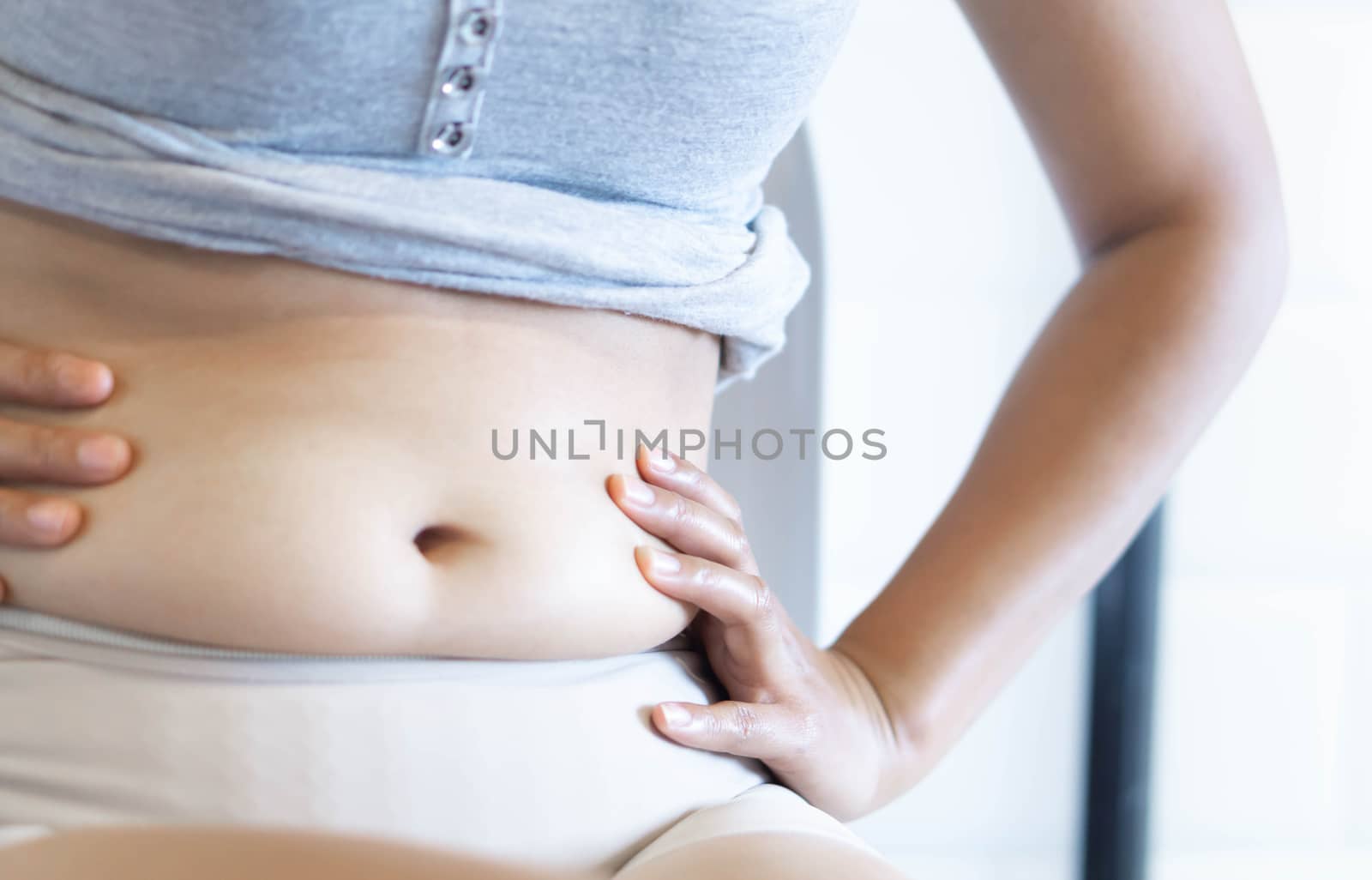 Closeup hand holding abdominal surface woman fat, healthy care a by pt.pongsak@gmail.com