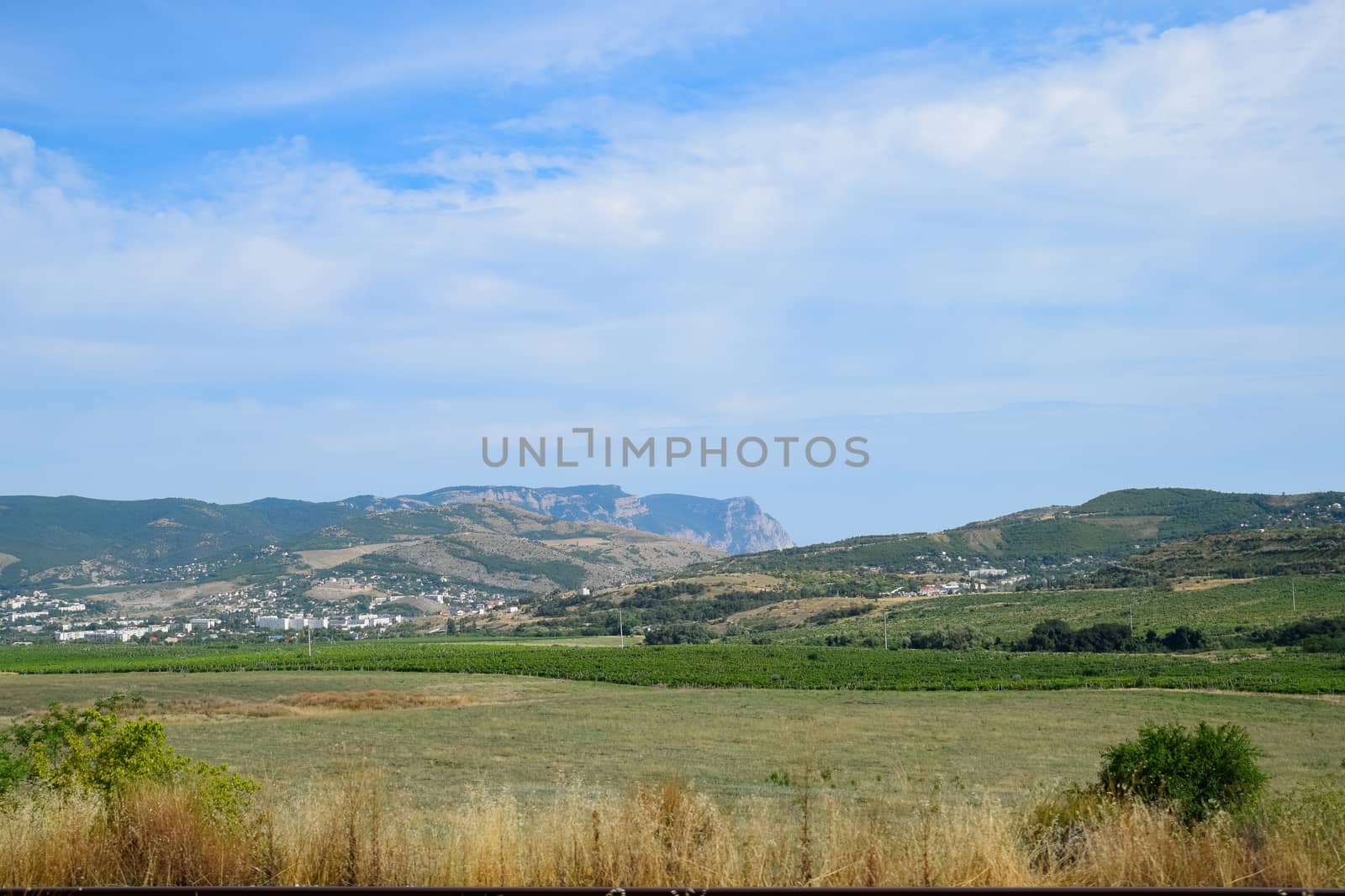 Landscapes of Crimean nature. Fields and hills visible from the car window from the road. by fedoseevaolga